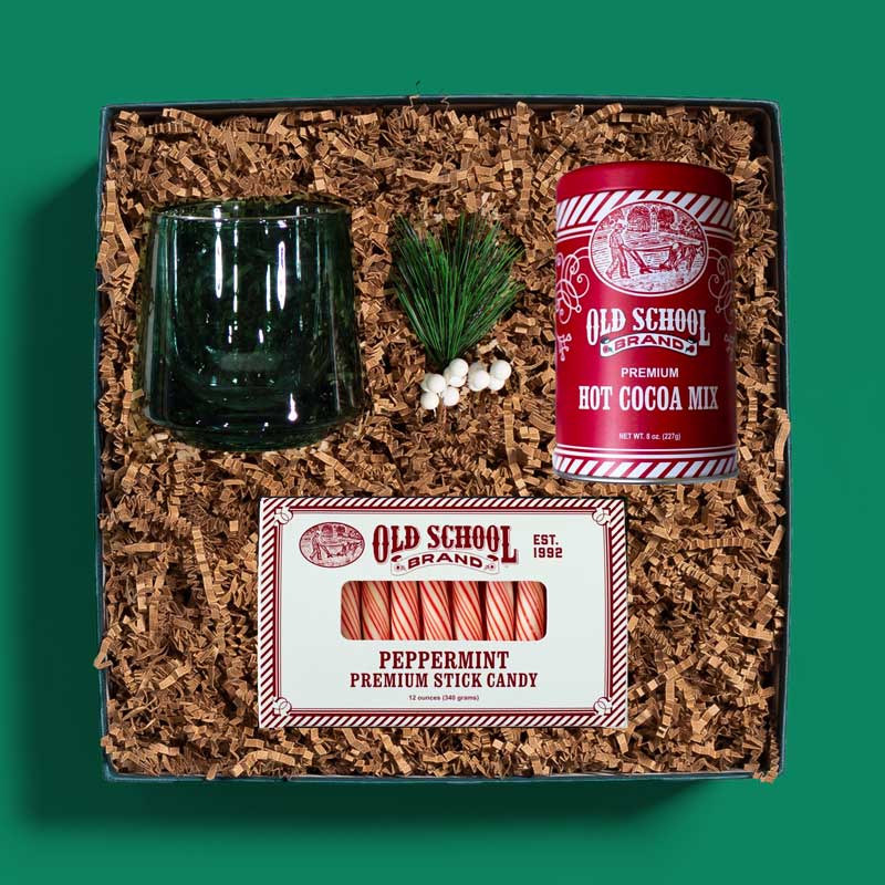 Corporate holiday gift box with a glass mug, hot cocoa mix and peppermint sticks