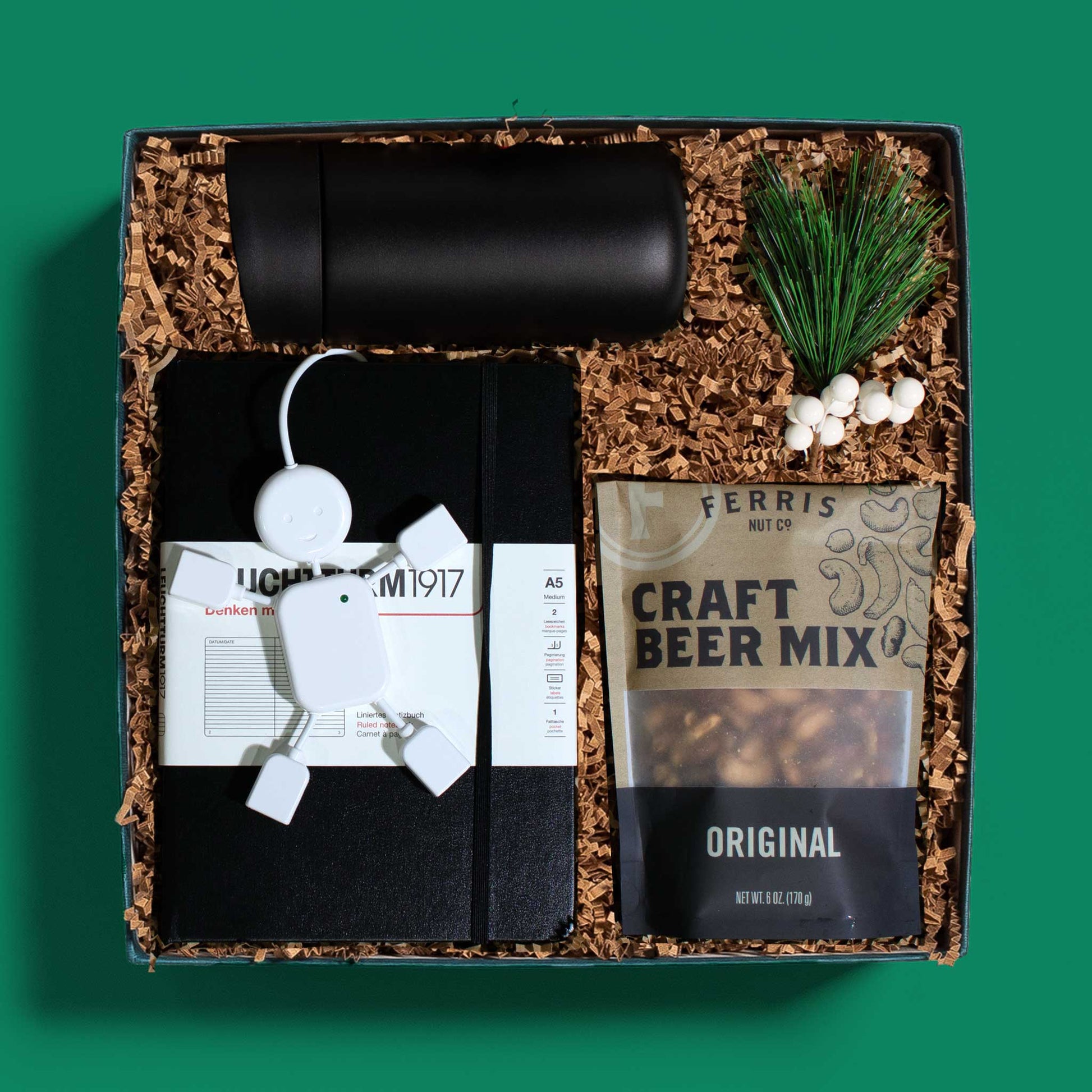 Luxurious gift box with a slide top thermal mug, lined notebook, snacks and more