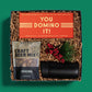 Fun, holiday gift box with a box of domino games, snacks and a thermal tumbler