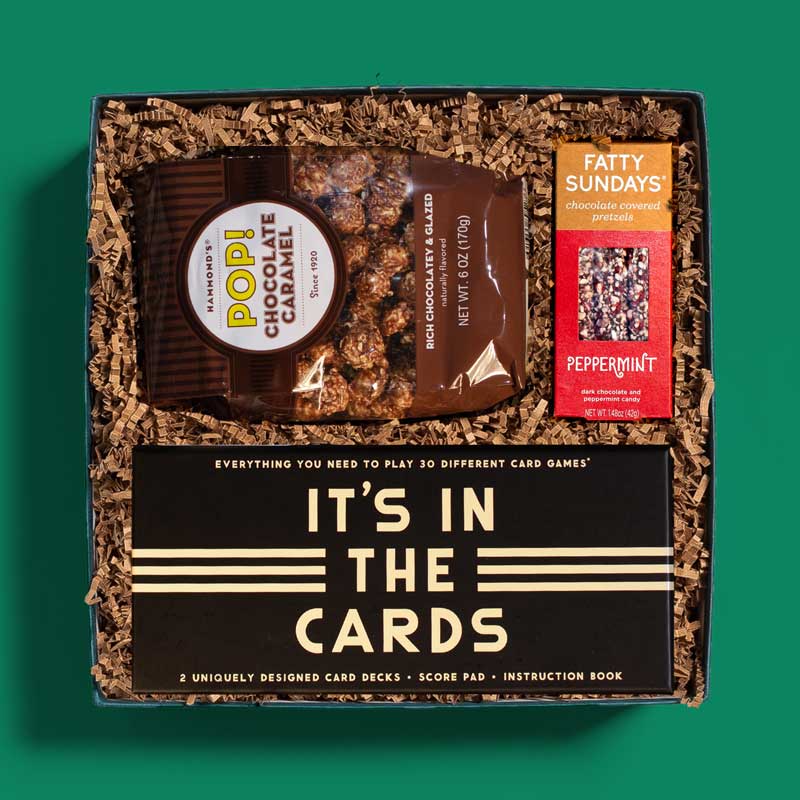 Corporate holiday gift box with sweet and salty snacks and a card game set