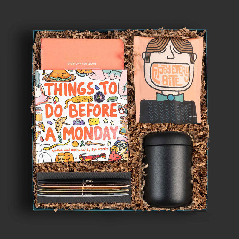 Curated corporate gift box with a travel mug, journal, pen, adventure book and more