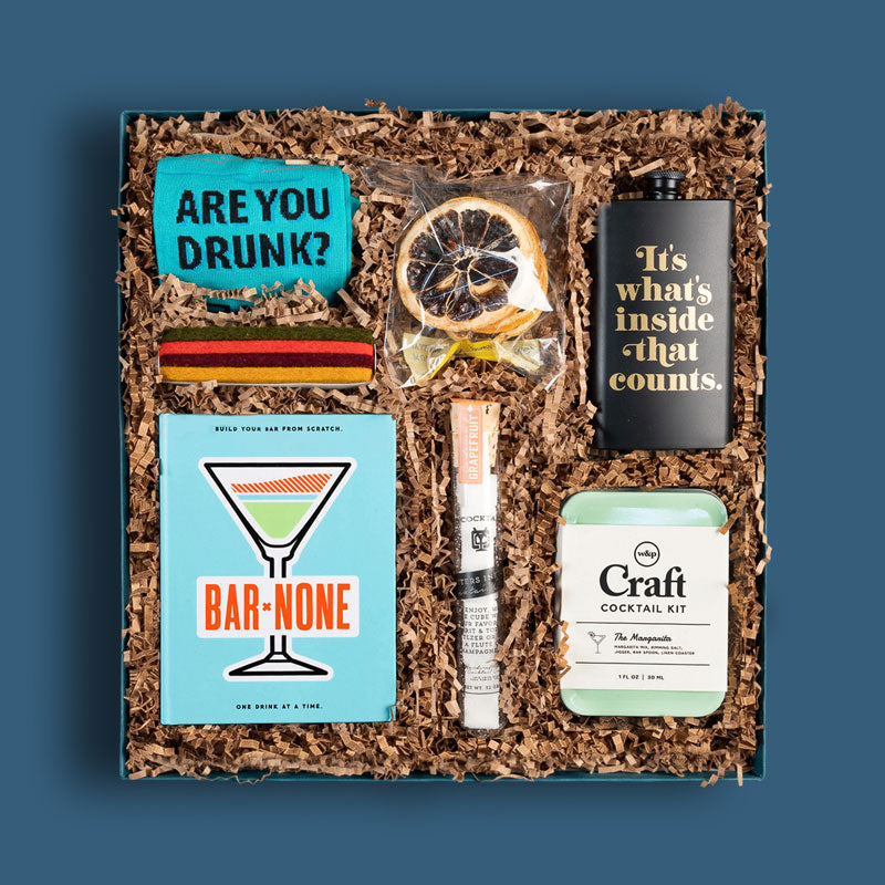 Brightlane corporate gift box with cocktail-themed gifts, including a flask and bar mixers
