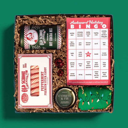 Christmas-themed gift box with a game, hot cocoa, candy, socks and more