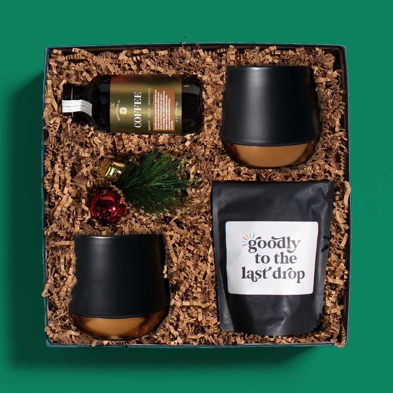 Luxurious holiday gift box filled with coffee beans, mugs and cocktail syrup
