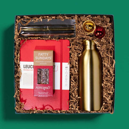 Elegant holiday gift box with a notebook, pen set, gold water bottle and more