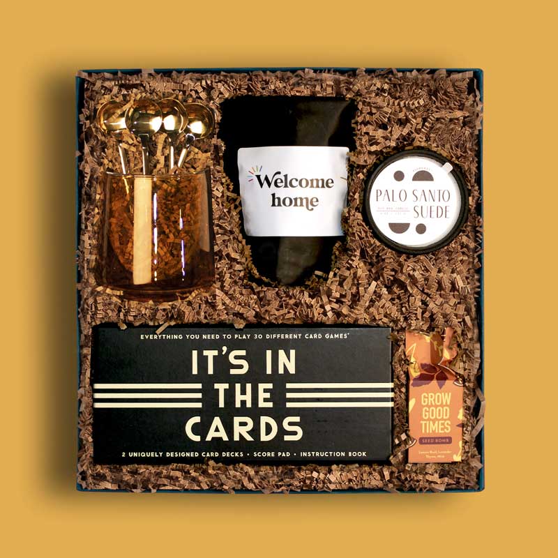 Unique and thoughtful housewarming gift box with coffee, games, seed bomb and more