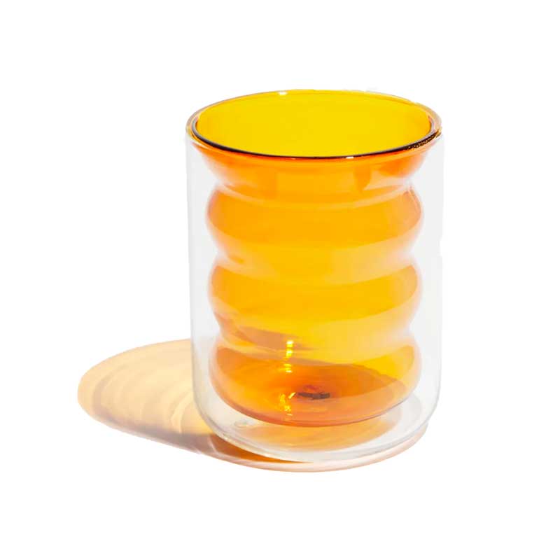 Hand blown double walled glass with a smooth, clear outer wall and a yellow, wavy inner wall